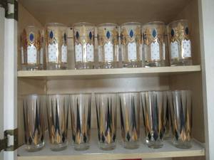lot 76 image: KITCHEN LOT INCLUDES RETRO DRINKING GLASSES, TUMBLER GLASSES, MEASURING CUPS, TUPPERWARE IN ALL SIZES, FLATWARE, HOUSEHOLD CLEANERS, RAGS AND MORE