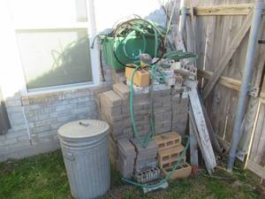 lot 96 image: GARDENING BRICKS APROX. 200, TRASH CAN AND HOSE AND MORE
