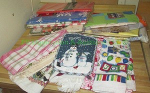 lot 133 image: Assorted dish towels & plastic table clothes unused in original packing