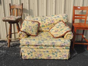 lot 146 image: Large chair and a half yellow with 2 throw pillows. Floral design      Wood box stool with back bar chairrr leg needs tightening