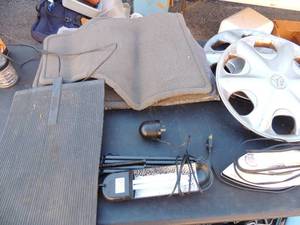 lot 67 image: 2 car hubcaps, heating mat with  plug, black & Decker iron, Black hanger lamps 4 gray car floor mats