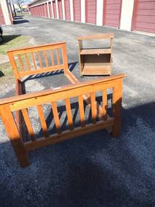 lot 95 image: Twin size bed frame solid wood needs nuts and bolts few stickers and scratches rolling shelf 2 shelves