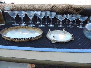 lot 198 image: 9 margarita glasses, 6 wine glasses 4 oval flower vases, glass mirror with little boys sitting on the side, Mirror with gold trim 13 x 9, 2 deek glassbook ends,candy jar with lidand whisky bottle