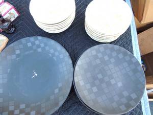 lot 215 image: 2 dish sets- black checkered Homebrand  1 large plate 5 salad bowls and the other is cream color no brand markings 6 bowls, 2 dessets bowls, 10 saucers