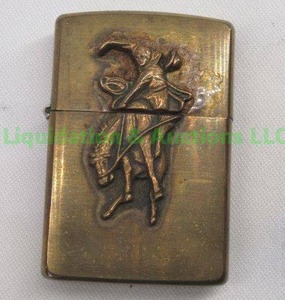 lot 23 image: Retro Zippo lighter, brass with embossed bucking bronco rider case