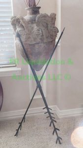 lot 34 image: Wrought iron triple arrow base stand with terra cotta pot & branch decor, approx 4ft tall