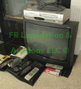 lot 124 image: RCA TV, Emerson VHS player and assorted remotes