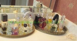 lot 143 image: Assorted colognes and perfumes plus mirrored trays
