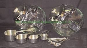 lot 67 image: Williams Sonoma stainless steel measuring cups & spoons plus glass counter top reach in jars