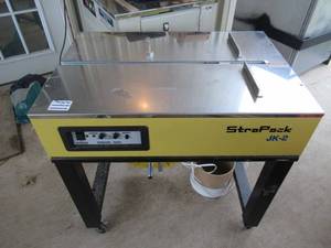 lot 113 image: STRAPACK JK-2 SEMI-AUTOMATIC STRAPPING MACHINE WITH NEW 8000 ROLL OF STRAP IN UNOPENED BOX. WORKS GREAT