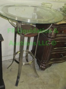 lot 18 image: Glass top metal base bistro table 30 wide x 40 tall, matches chairs in lot 263
