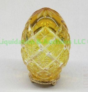 lot 193 image: Faberge yellow crystal cut to clear egg on stand