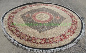 lot 43 image: Persian Tabriz hand woven wool rug Concentric design traditional design. Size 81 x 8 2 round with fringe. Hand knotted.