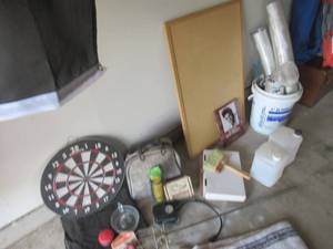 lot 79 image: MISCELLANEOUS LOT INCLUDES DRYER HOSES, 2 SMALL WATER CONTAINERS, ELVIS PRESLEY BOOK, ROTISSERIE, JUICER, UTILITY BATTERY CABLE, DARTBOARD AND RUG