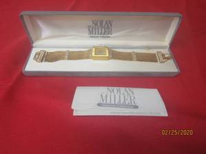lot 62 image: NOLAN MILLERGOLD WATCH WITH RHINESTONES IN ORIGINAL CASE WITH COA