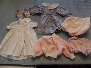 lot 137 image: DOLL CLOTHING - SHOES,   PINK SWEATER,   BLUE CHECKED DRESS,  WHITE DRESS   BONNET  BLOOMERS