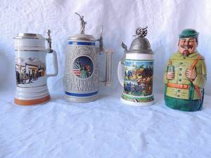 lot 74 image: BEER STEINS - COORS WINTERFEST 94-95 LIM. EDITION 22319950 THAILAND   STATUE OF LIBERTYAMERICA THE BEAUTIFUL  AVON 1982   VINTAGE BMF BLUE MUSKET TOP (PEWTER CANNON) BIERSEIDEL LIDDED-WEST GERMANY GREEN SOLDIER BEER STEIN -ECKHART W. GERMANY 9X6X4.5