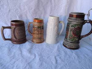 lot 76 image: STEINS - JOHN WAYNE - CHINA THE DUKE STEIN - JAPAN WHITE STEM -BLACKWELL   OLD GERZ -AUS UNSERM FIRMEN-ARCHIN LIDDED STEIN GERMANY -  QTY 4