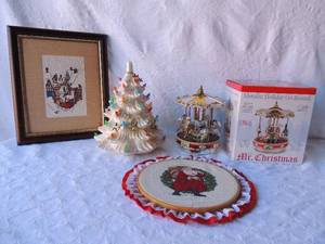lot 112 image: Christmas dcor- Mr. Christmas metallic go round Santa cross stich , white ceramic Christmas tree 11x12