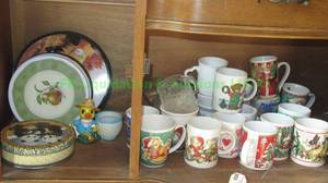 lot 92 image: Assorted cups and more as shown, contents of bottom cabinet shelf
