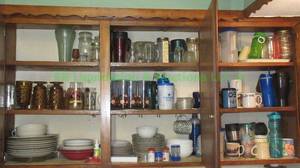 lot 112 image: Assorted dishware as shown, contents of cabinet