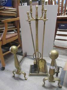 lot 9 image: SOLID BRASS ANDIRONS AND FIREPLACE TOOL SET WITH STAND  TOOLS HAVE SOLID BRASS HANDLES AND BRASS COATED WROUGHT IRON SHAFTSS
