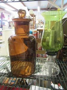 lot 76 image: AMBER GLASS JAR 16 TALL AND GREEN GLASS LANTERN