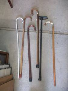lot 242 image: 4 WOOD CANES AND 1 METAL CANE