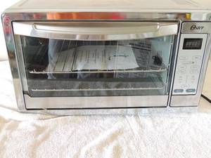 lot 50 image: Oster convection oven clean inside and works includes instructions