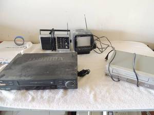 lot 56 image: Electric lot- Toshiba VHS player no remote, Philips VHSDVD no remote, Radio Shack Port vision TV 12 Portable GE AMFM radio all unknown working order