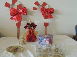 lot 63 image: Christmas lot- 13 tree in box, 6 tier candle holder, 2 candy came Christmas wood yard art, porcelain angel and more