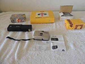 lot 75 image: Box of new dissmore hones 28 mm optical lens cameras electric   Kodak flash adapter    instamatic 104 outfit Kodak camera in box