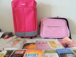 lot 115 image: Embark pink rolling suitcase hot pink laptop computer bag lot of cancer information and books