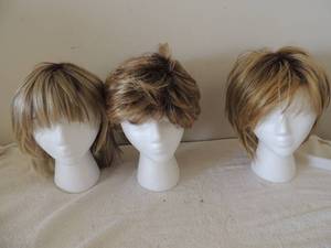 lot 123 image: 3 wig holders and 4 wigs