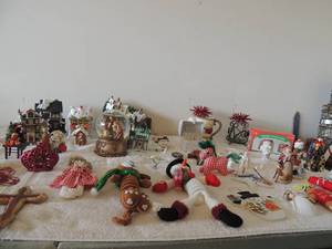 lot 21 image: Christmas houses, Tree dcor, 6 Santa kids, snow globe of baby Jesus and much more including handmade items
