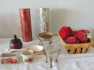 lot 28 image: 2 dcor 12 slim tin cans , porcelain basket with apples x 5, gold candle stand, rooster spoon rest salt and pepper holder