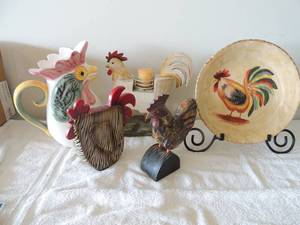 lot 29 image: Rooster lot 1 display plate on stand 11, wooden rooster candle holder with  10x10 candle rooster tea pitcher 8 qt. 2 small decorative roosters both 9x8