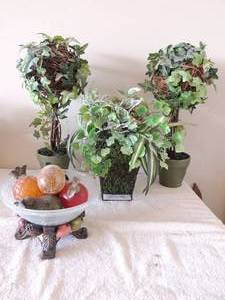 lot 30 image: 2 small porcelain planters with faux plants and wicker balls to hold plans glass bowl with fruit stand and wire basket planter