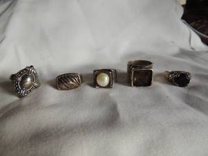 lot 178 image: SILVER RINGS (MARKED 925) -  QTY OF 5  PEARL CENTER,  SMOKY FACET STONE, ROUND DARK STONE,  2 ORNATE SOLID RINGS   TW OF THE 5 IS 46GMS. - SIZES 7-7.5