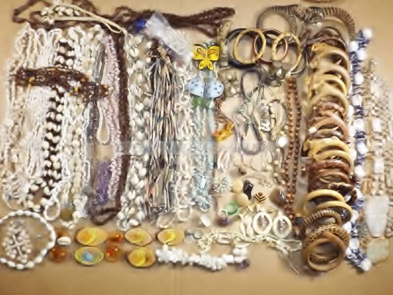 lot 111 image: Rock, jewelry, shell, gold plate, carved bone, maile, wood, bracelet