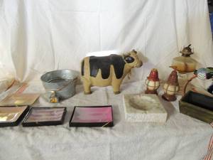 lot 43 image: Dcor cow, metal bucket, 4 NIB trays, large 6x6 ashtray, 2 lantern style soap dispensers and oil lamp