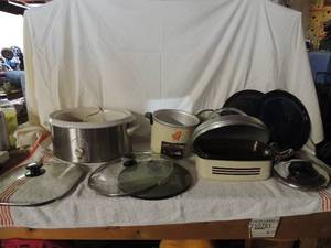 lot 53 image: Large lot of pots and pans with lids west bend crock pot no lid unknown working condition, small Hitachi cooker missing one leg no top.
