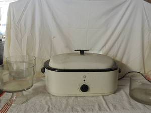 lot 64 image: 2 glass cake stands with covers, large GE slow cooker like new unknown working condition