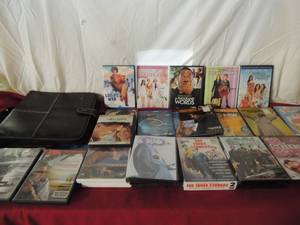lot 69 image: DVD carry case and large lot of movies some NIB comedy and childrens