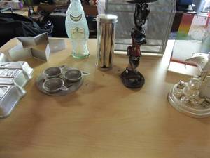 lot 123 image: Metal jello mold of house, star cutter, cowboy boot candle holder 2 metal mail files baby photo carousel and more