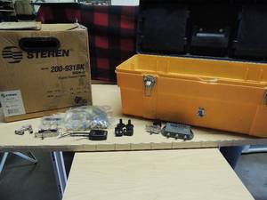 lot 148 image: yellow toolbox full of cable acc. Extenders, seperator,splitters,roll in box of STEREN  cable wire 200-932