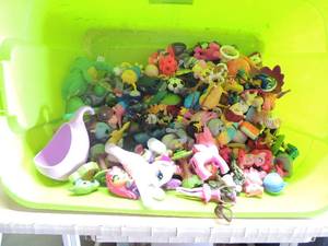 lot 178 image: Green tote full of small toys-Hello Kitty, dolls, horses, balls, dogs, cats and lots more