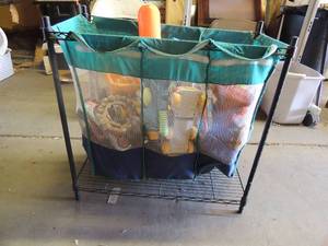 lot 179 image: 3 bin laundry  net holder includes lots of trucks, dinosaurs, cars, and more