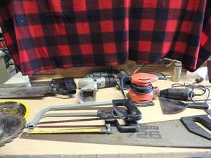 lot 211 image: 5 sizes of handsaws , oil and grease gun 395 dremel tool B&D sader various saw blades, create meckdrill no battery or charger B&D 9.6 drill no battery or charger