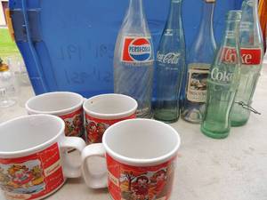 lot 239 image: 4 Campbells soup cups, 3 coca cola bottles 1 Christmas Chateau St. Nicholas white wine bottle 1 Pepsi cola glass bottle